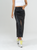 Ref: 067900 Falda efecto cuero, cargo, rígido, tono negro, diseño con bolsillos y corte delantero