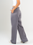 Ref: 069669 Pantalón mom flare, sin prense, tono gris, tejido plano liviano, efecto satinado, tiro alto