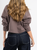 Ref: 0610387 Chaqueta cropped, tono cafe, bolsillos con taches y broches delanteros